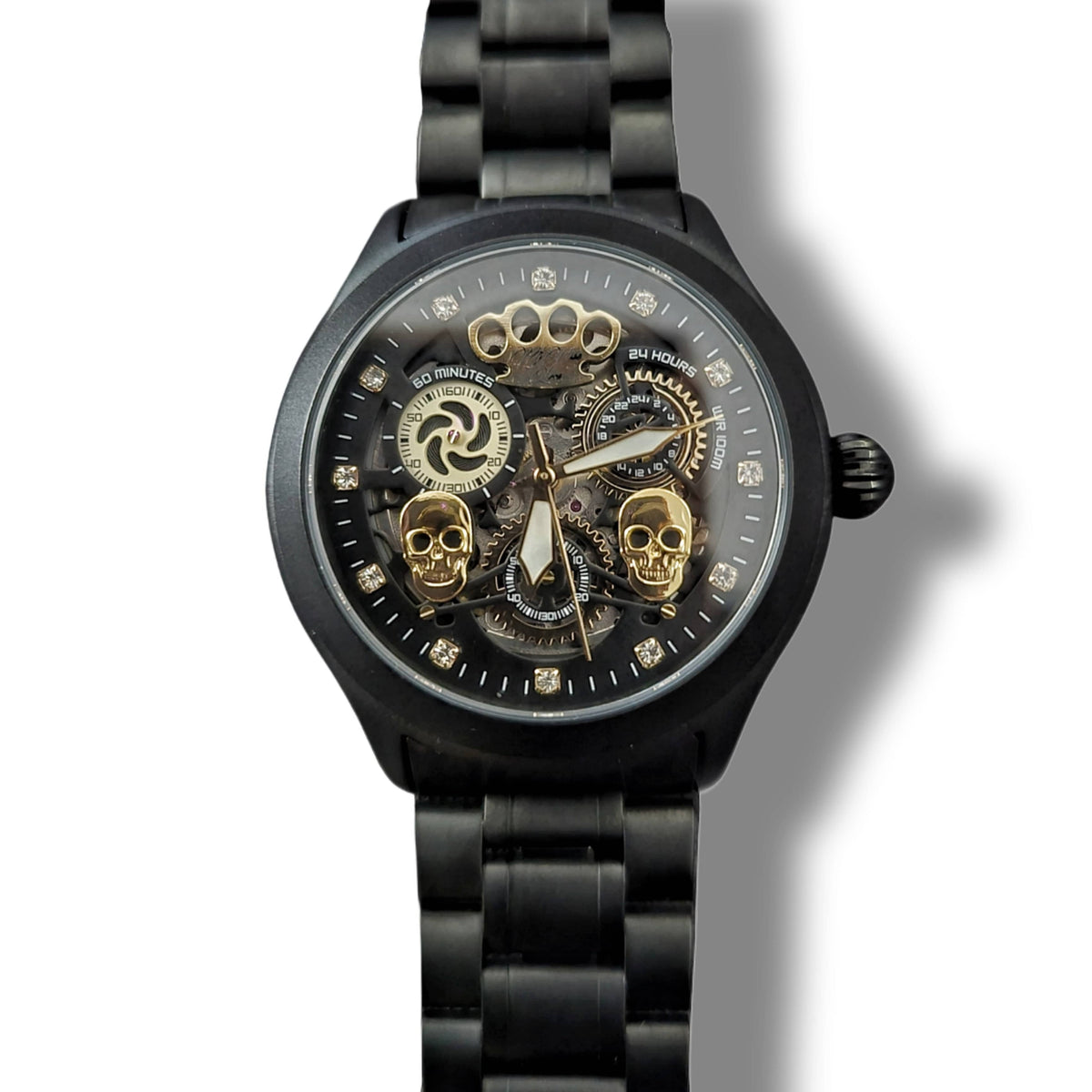 Front of the matte black Double skull watch with two gold skulls and open movement
