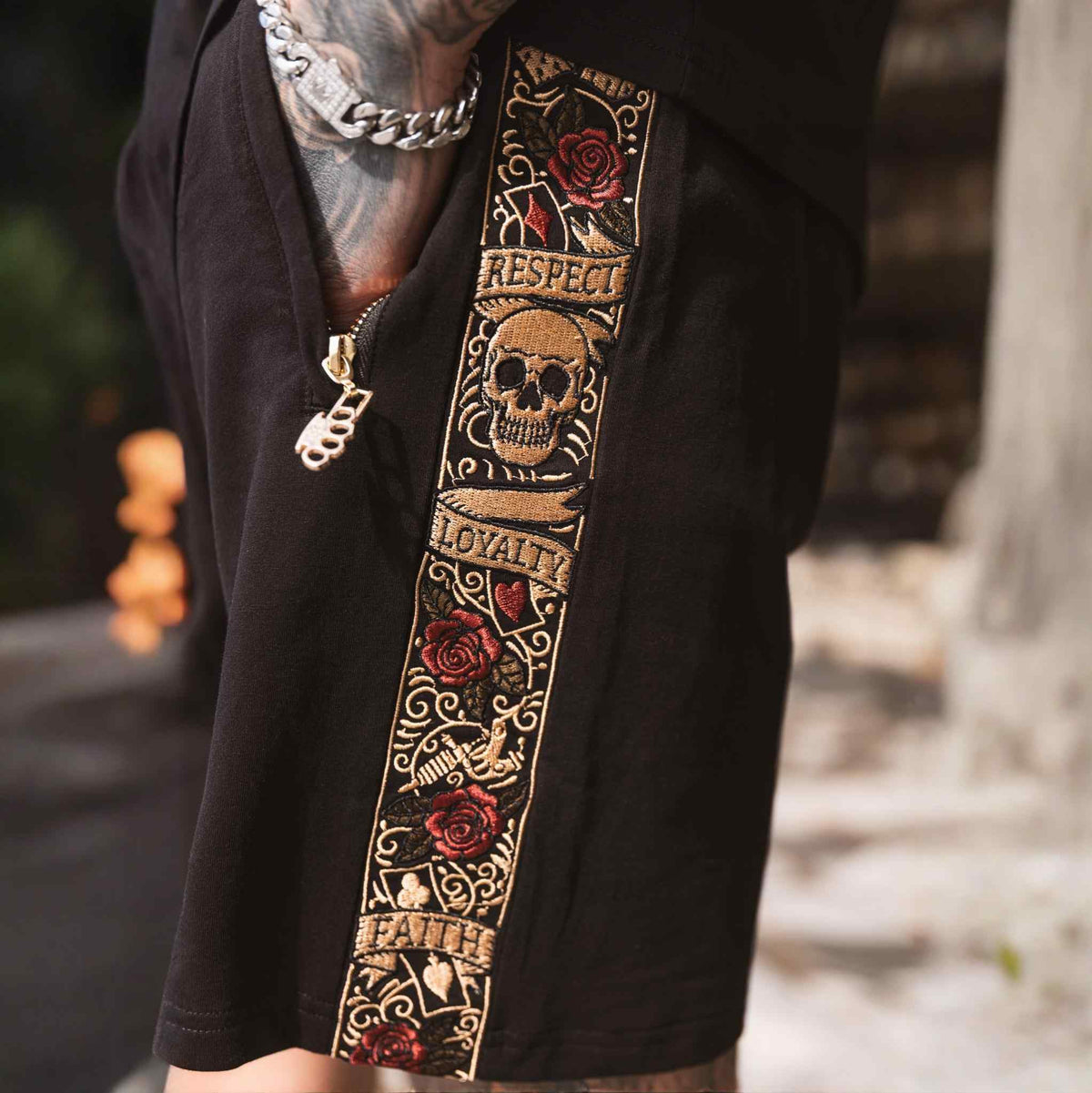 Close-up of the LFR embroidered band with skull, roses, Respect, Loyalty and Faith on the jogger shorts