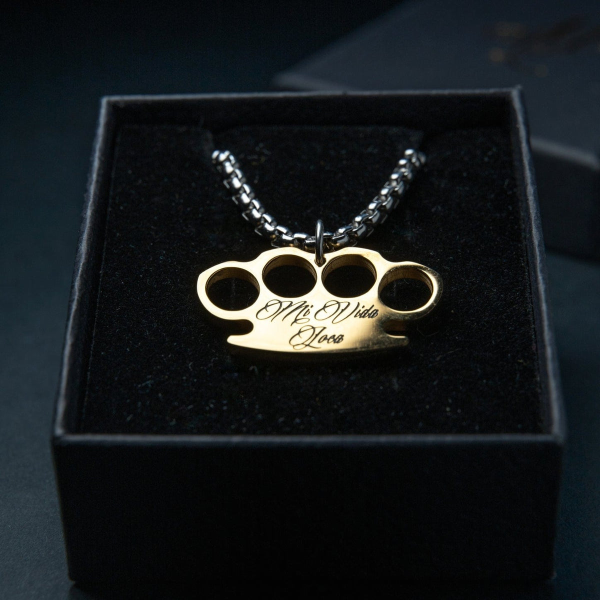 Mi Vida Loca MVL Logo necklace in silver with gold MVL logo pendant and engraving, in a black box