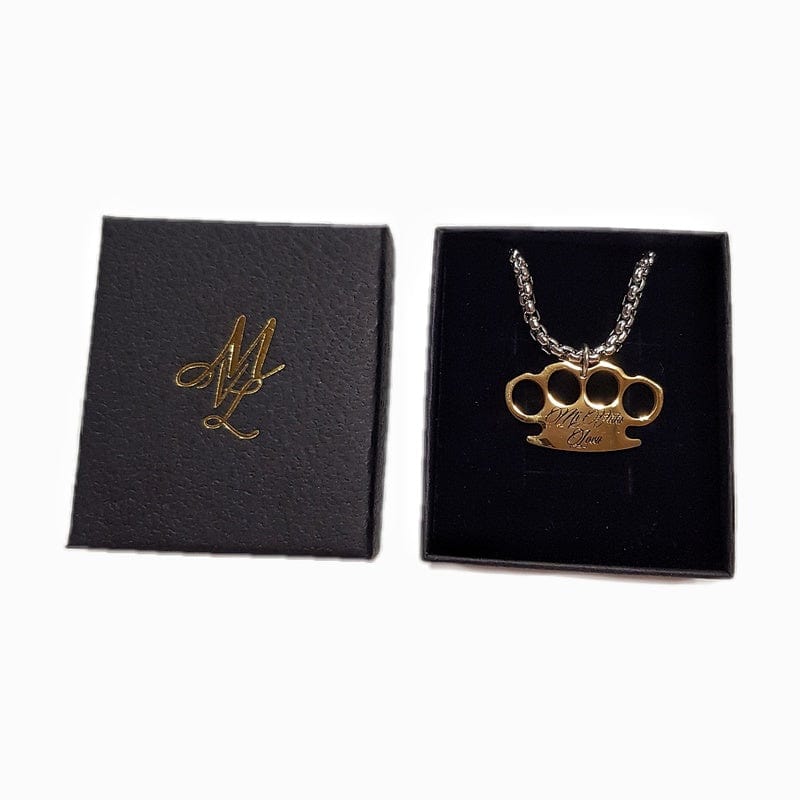 MVL Logo necklace with gold MVL logo pendant in a gift box next to the lid with ML monogram